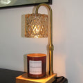 Wall-mounted lamp with decorative glass shade and candle holder against a white wall.