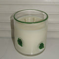 Clear container with green leaf decorations on a white background