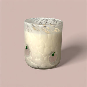 Decorative glass candle holder with marble pattern on a pink background